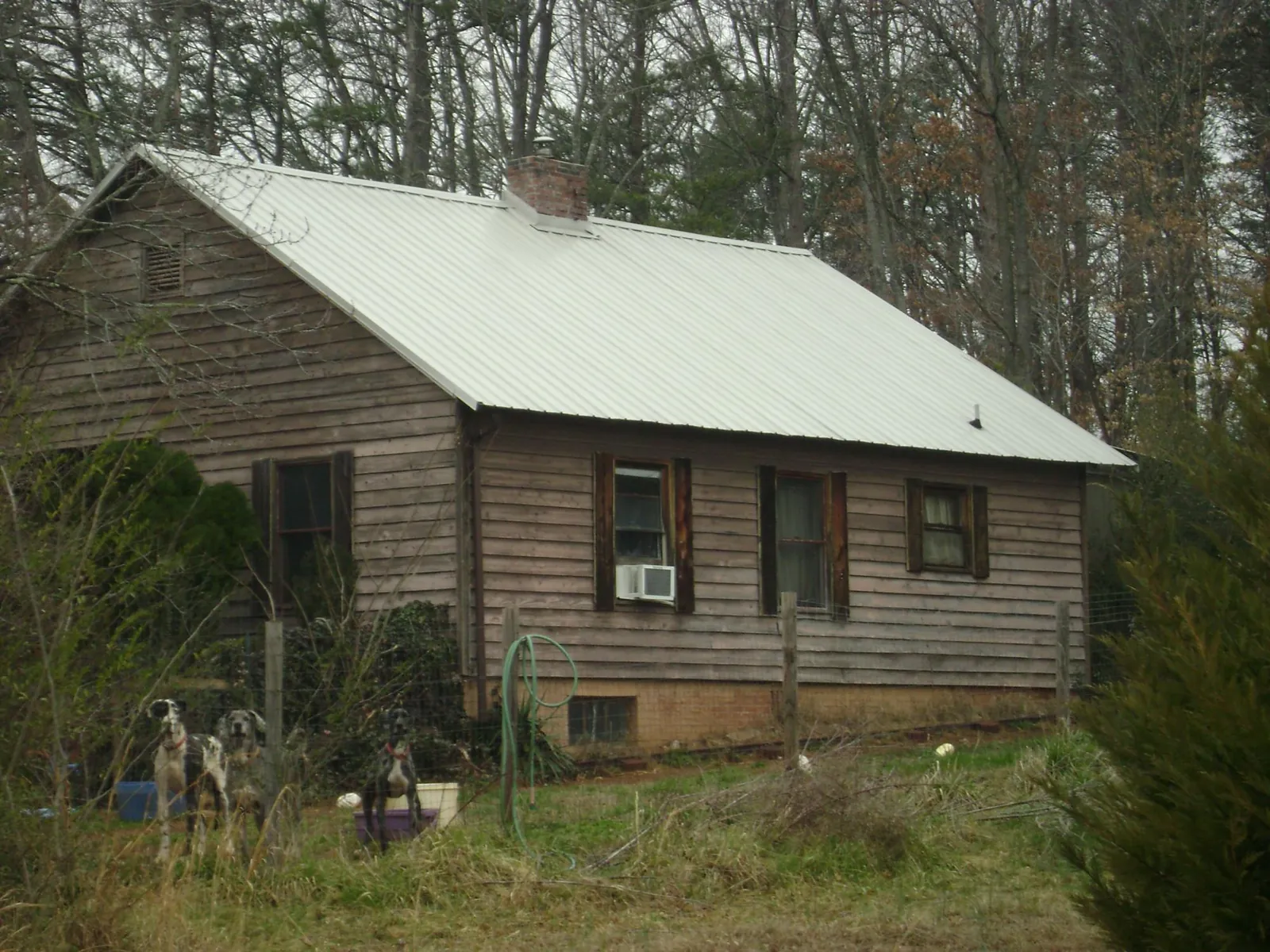 White metal roof on an old wood sided farmhouse, from a Metal Roof Installation job in Streamwood